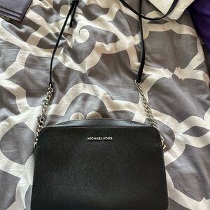 Micheal Kors crossbody black with silver details. With zipper. Gently loved.
